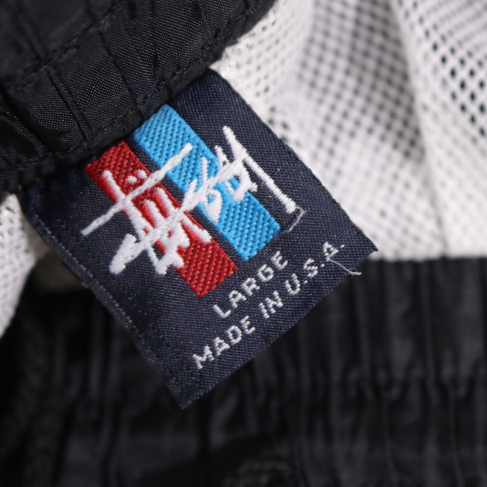 STUSSY 90s-00s | "Red & Blue Tag" Nylon Track Pants "Black / Orange